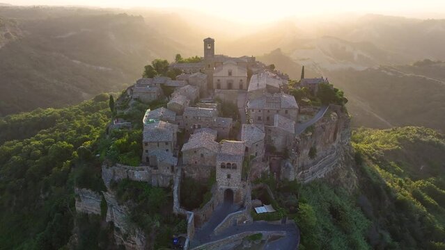 Civita di Bagnoregio, aerial view at sunrise, located on top of a volcanic tuff hill overlooking the Tiber river valley, province of Viterbo, Lazio, Italy