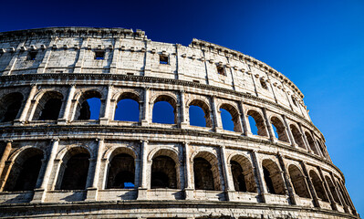 Fototapeta premium The Ancient Colosseum of Rome with Blue Sky