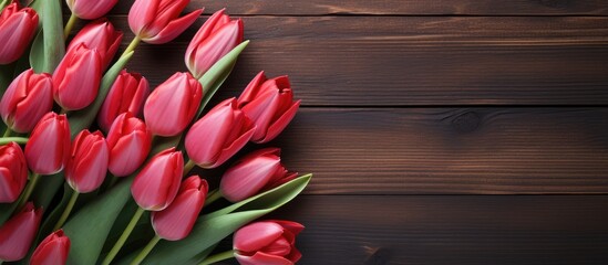 Mother s Day themed background featuring red tulips on a wooden surface symbolizing spring flowers