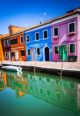 Very Colorful Row Houses with Boats and Water Reflections in Venice Italy 