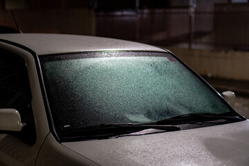 car glass wet from rain at night.
