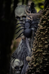 Halloween decorations in a gloomy dark forest. Skull and skeletons in a dark forest.