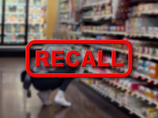 Blurred background of a woman shopping inside a grocery store with the red text Recall in the...