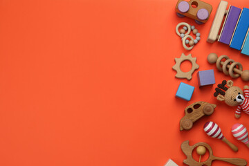 Different children's toys on orange background, flat lay. Space for text