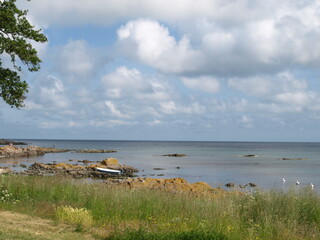 Blue sky with beautiful rocks at the water's edge