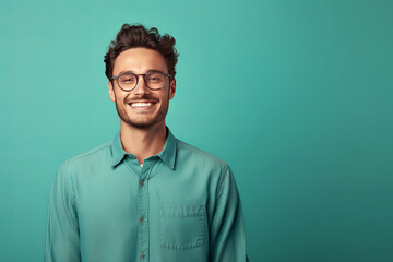 Portrait of young smiling man wearing glasses isolated on turquoise background with space for inscriptions or text.generative ai
 - Powered by Adobe