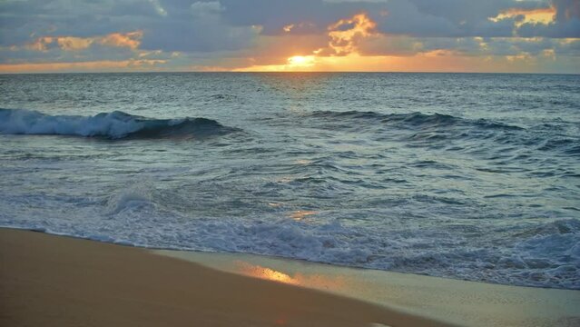 Sun setting on ocean horizon