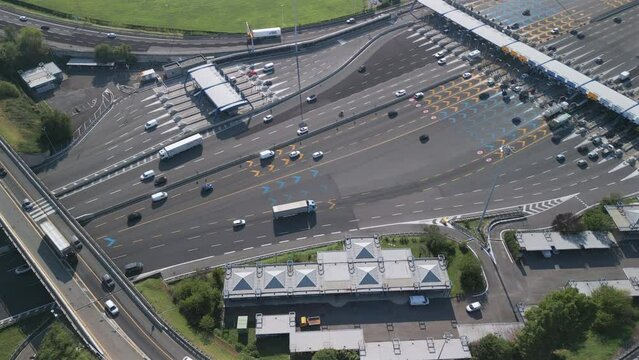 Aerial view of an Italian highway toll booth. Time-lapse cars queuing up to pay the highway toll and automatic paying lanes.