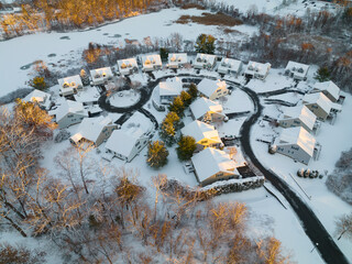 aerial view of residential community in winter after snow under sunlight