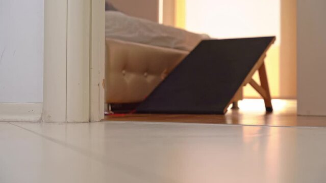 Man fussily runs out of bedroom, close-up of his feet on floor in doorway in jeans Bad date, lovers caught red-handed in bed, retreat Night watch, emergency call burglar alarm Urgent business, be late