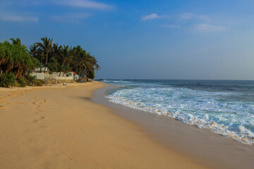 Beach with golden sand and blue ocean water on most popular Unawatuna