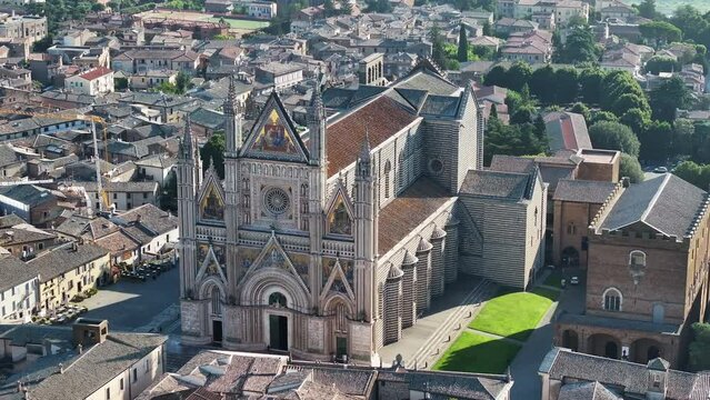 Aerial shot of Duomo di Orvieto or Cathedral of Orvieto, iconic Italian Gothic architecture in Umbria, Italy