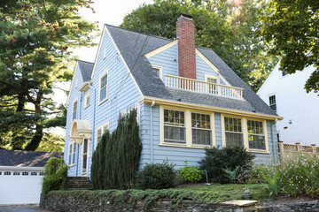 suburban house symbolizing the mortgage housing crisis, rising prices, and inflation in the housing market, with a worried homeowner in front