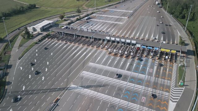 Aerial view of an Italian highway toll booth. Time-lapse cars queuing up to pay the highway toll and automatic paying lanes.
