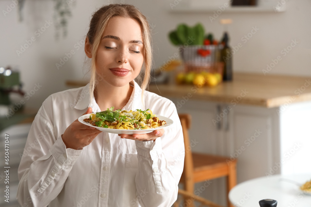 Sticker young woman with tasty pasta in kitchen