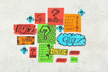 Paper quiz cards with question marks on grunge white background
