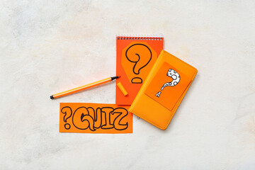 Notebooks and quiz cards with question marks on grunge white background
