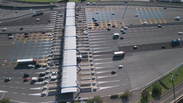 Aerial view of an Italian highway toll booth. Time-lapse cars queuing up to pay the highway toll and automatic paying lanes.