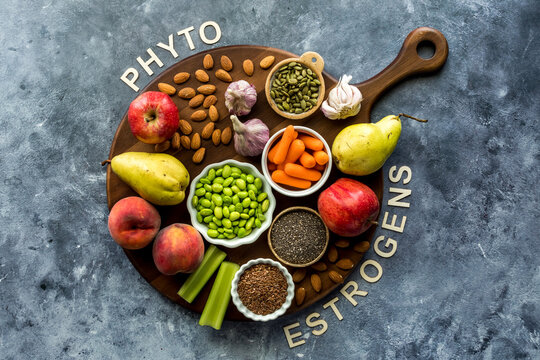 Healthy foods that are high in phytoestrogens on a wooden board against blue.