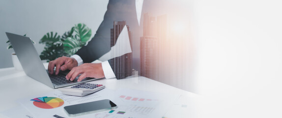 Business accounting concept. Business uses calculator with laptop computer, budget and income...