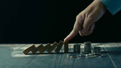 Economic collapse concept, hands stop domino crisis effect, financial and banking problems,...