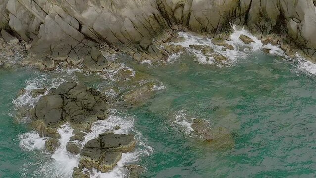 Aerial Serenity Over Tranquil Turquoise Waters and Coastal Rocks in Looc, Romblon, Philippines