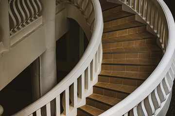 Background image of a unique curved staircase.