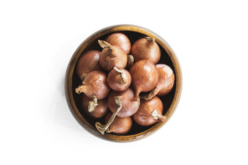 Red onions in wooden bolw  on white background.has path
