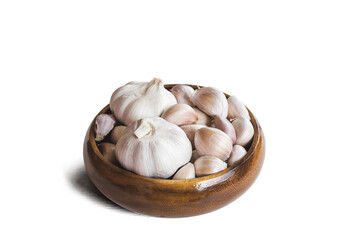 Garlics in wooden bolw  on white background.  Have path