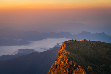 Sunrise behind cliff with mountain range with sea of cloud in the morning (Tak province, Thailand)