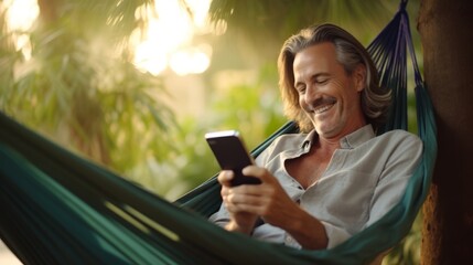 cheerful retired happiness adult male man surfting social media interinet with tablet device while relax in hammock with garden backyard daylight