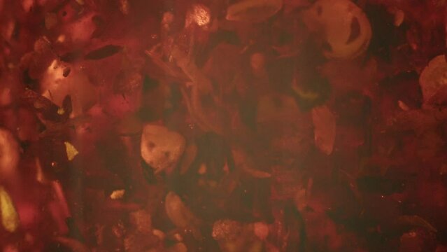 Macro shot of chili oil moving in a glass bottle