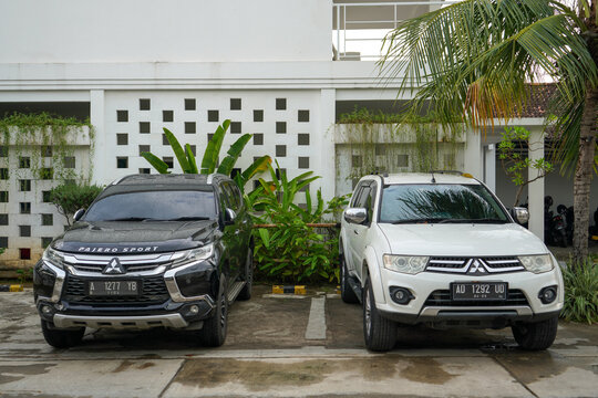Jepara, Indonesia - September 21, 2023 : 
Two large black and white Mitsubishi Pajero Sport SUVs are parked in the park.