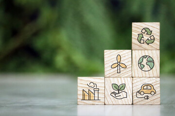 Save of earth, saving environment, net zero emissions concept. Green business and sustainable development. World earth day. Hand puts wooden cubes with clean energy icon standing on eco friendly icon.