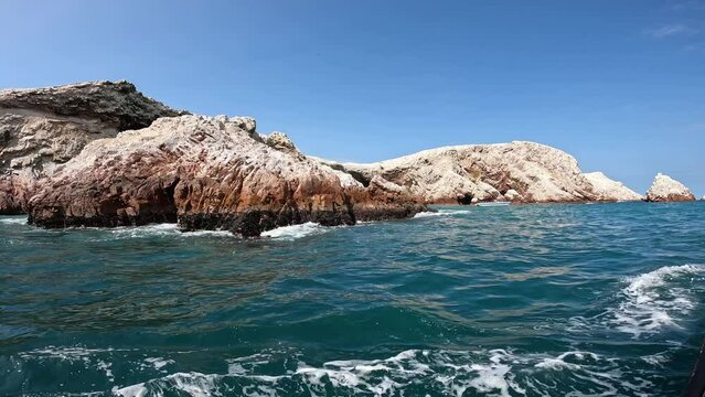 Sailing on motor boat along Ballestas islands in Peru