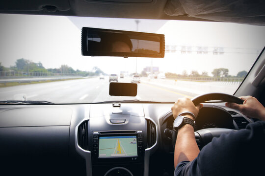 Man driver hands holding the car steering panel, Travel car trip on road concept