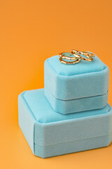 Blue jewelry box on yellow background close up