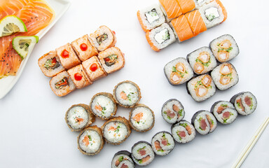 Japanese food. Sushi rolls and chopsticks on white background