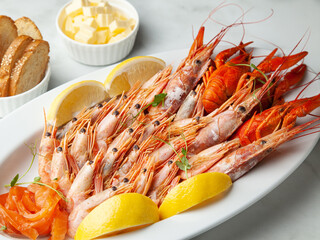 Langoustines and shrimp with garlic butter, lemons and bread 