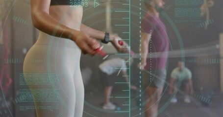 Animation of data processing over diverse woman and man jumping rope cross training at gym - Powered by Adobe