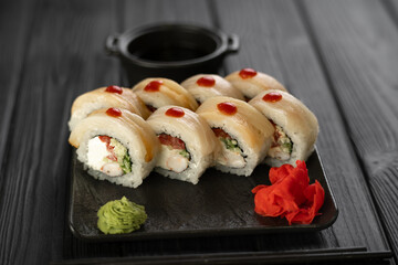 Sushi set with caviar, avocado and salmon. Asian cuisine. Top view. Free space for your text.