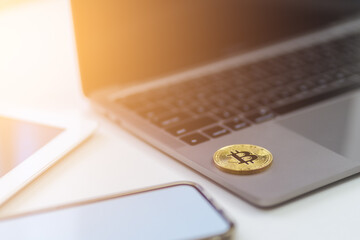 Gold Bitcoin Crypto investment and trade concept. Bitcoin Cryptocurrency logo symbol on computer laptop and tablet on white desk with copy space for texting. Virtual Crypto coin as Bitcoin is future. - 650558633