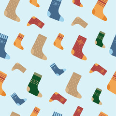 Seamless pattern with woolen socks of different colors and with different patterns on a blue background. Vector illustration