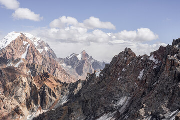 Fototapeta na wymiar Sharp and snow-capped mountain peaks in Tajikistan