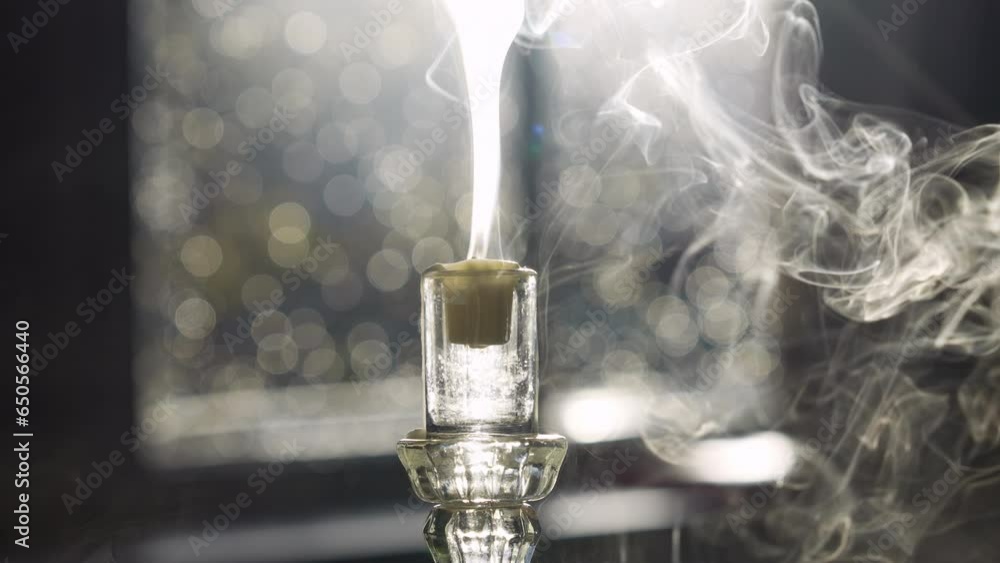 Poster blowing out a candle with blurred bokeh in the background. - closeup