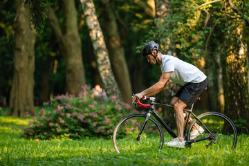 Man in sportswear riding a bike and looking excited
