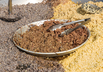 porridge from various grains is cooked over an open fire.