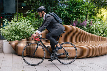 Young manager commuting to the office on a bike