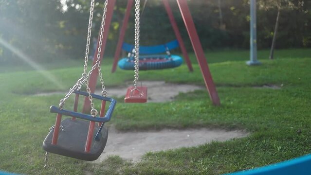 Playground swing set. Children swing in the park. High quality FullHD footage