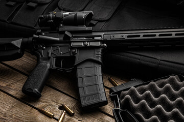 Modern automatic rifle on a wooden background. Weapons for police, special forces and the army. A...